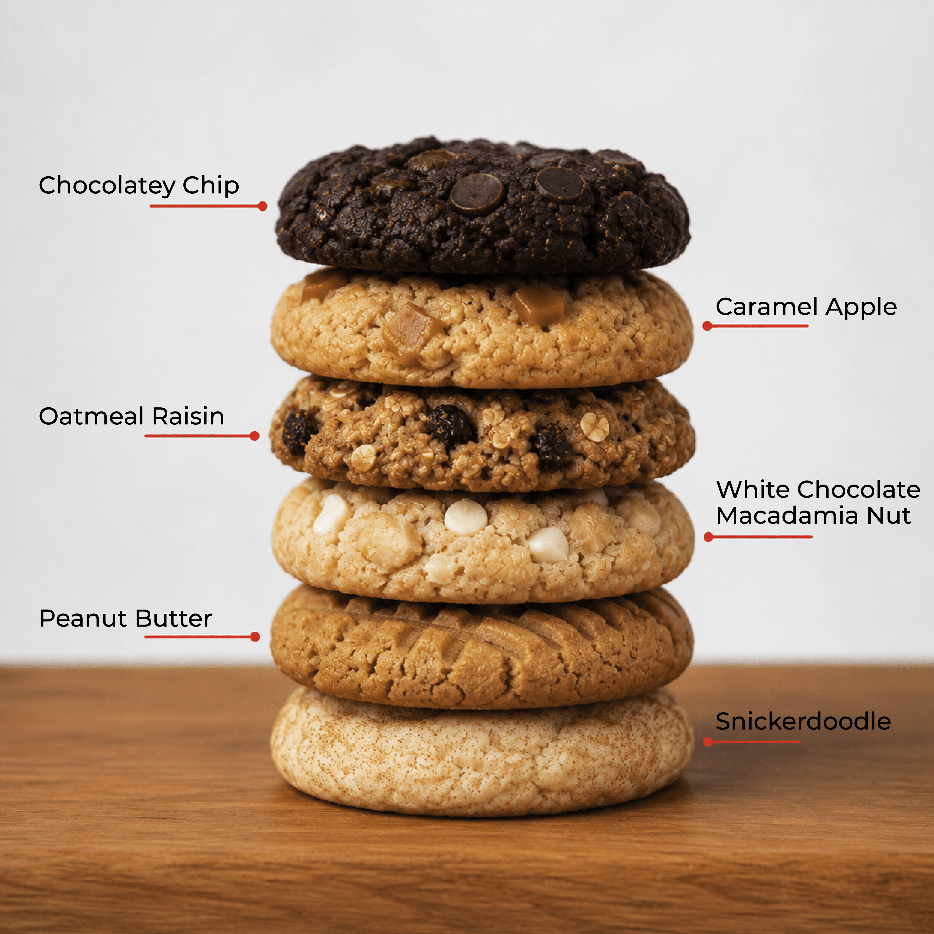A stack of six David's Cookies flavors: Chocolatey Chip, Caramel Apple, Oatmeal Raisin, White Chocolate Macadamia Nut, Peanut Butter, and Snickerdoodle.