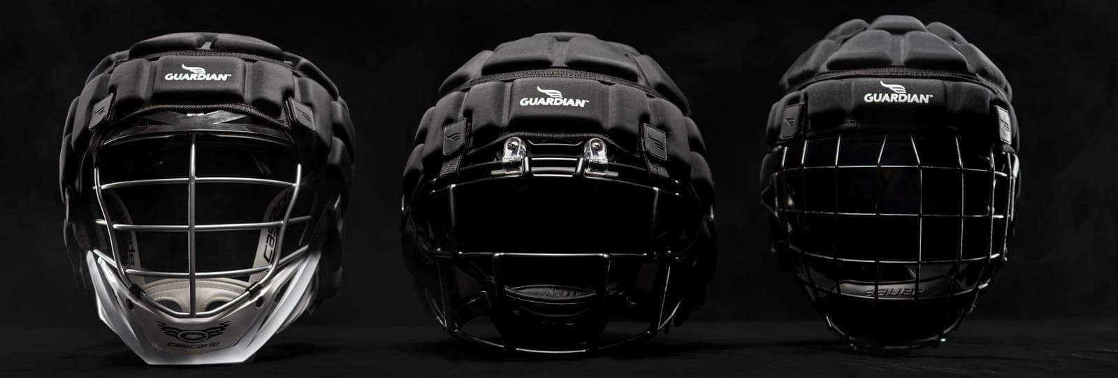 Three Guardian Caps fitted on football helmets