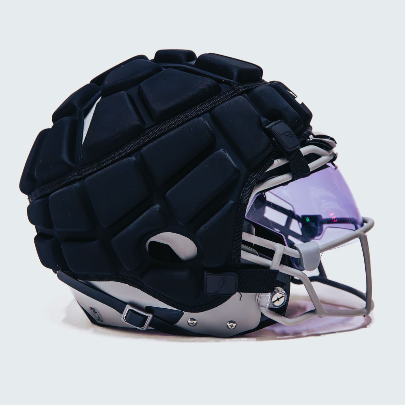 A Guardian Cap fitted over a football helmet