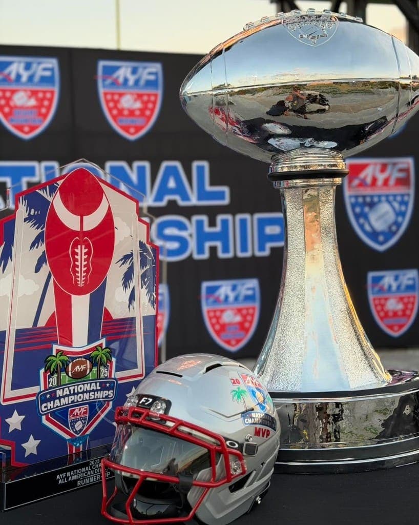 A championship trophy and helmet displayed at a national football championship