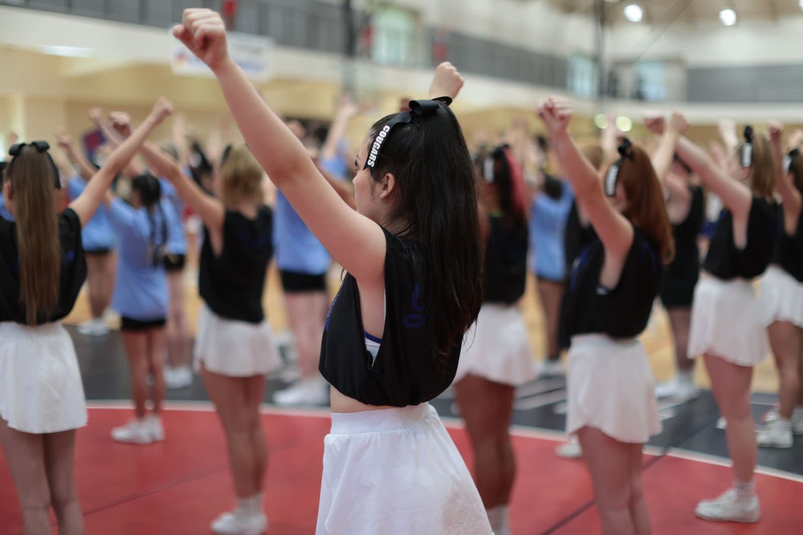 A Varsity Spirit cheer team practicing in a gym